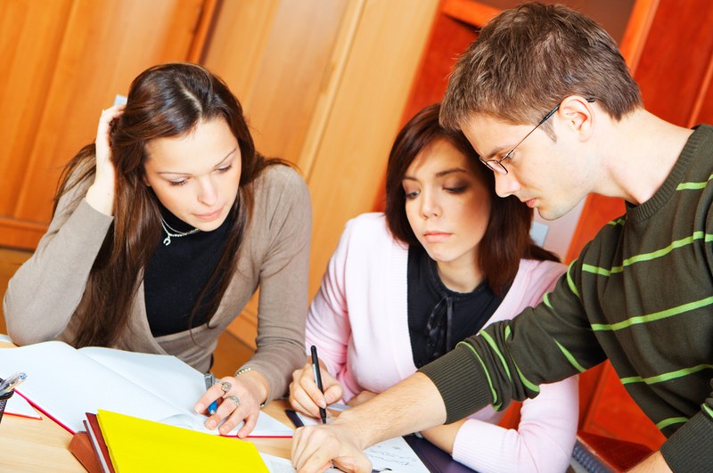 students at a table with learning documents