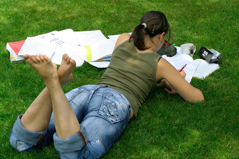 female student learning in the grass